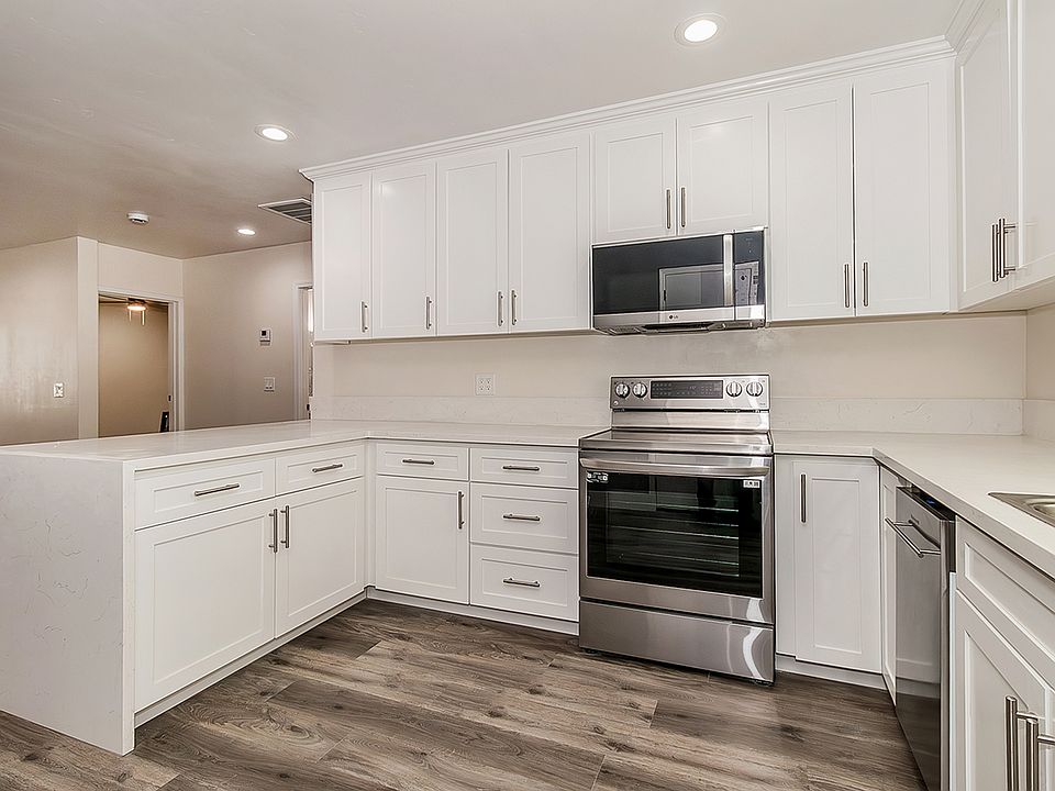 Updated Kitchen with Quartz Counter tops, high end appliances, LVP flooring, custom cabinets to the ceiling with soft close cabinets.