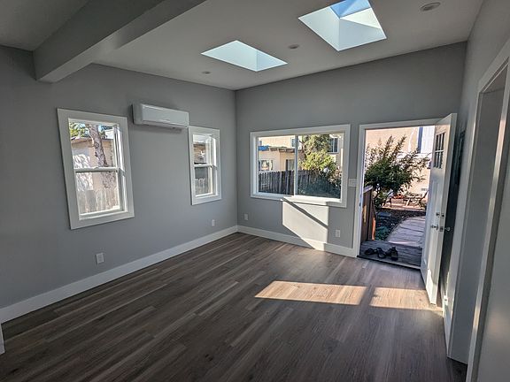 Open plan living area with windows facing the garden and skylights!
