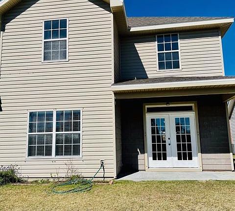 Back of home with covered patio