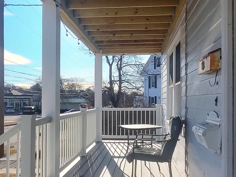 The front porch is ready for your outdoor furniture and morning coffees.