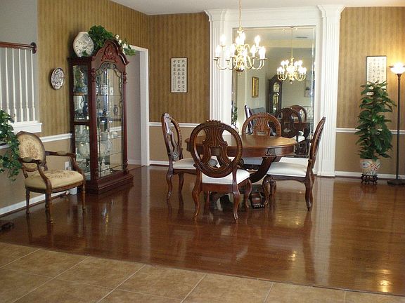 Formal Dining Room with hardwood floors and framed mirror