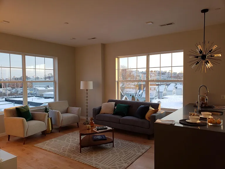 Living room and kitchen from entryway. (This was the staged showroom of the same floor plan, but one floor up).