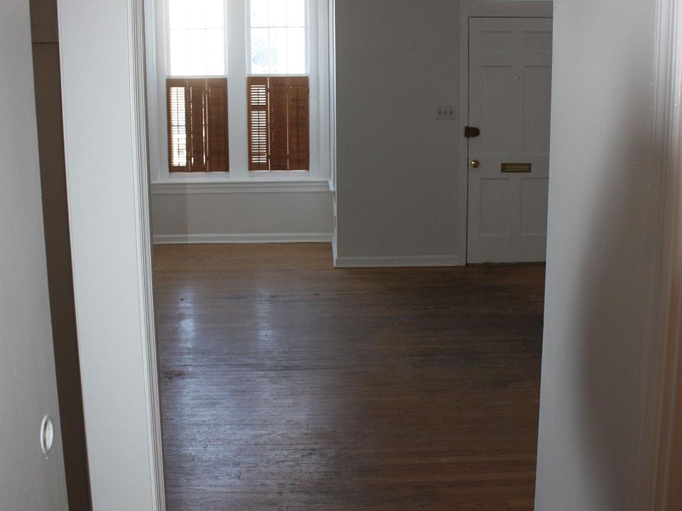 Living room from the kitchen, closet on left and half bath on right