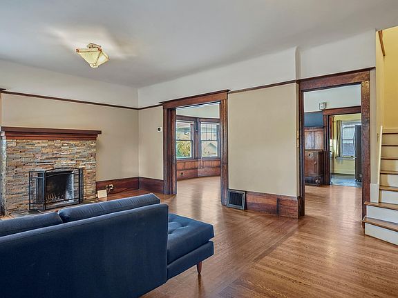 Staircase to the upstairs is on the right, with view into the dining room.