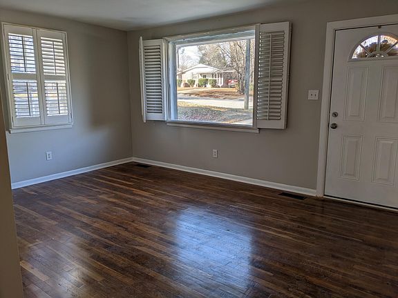 Living room with fresh paint, and newly refinished oak hardwood floors!