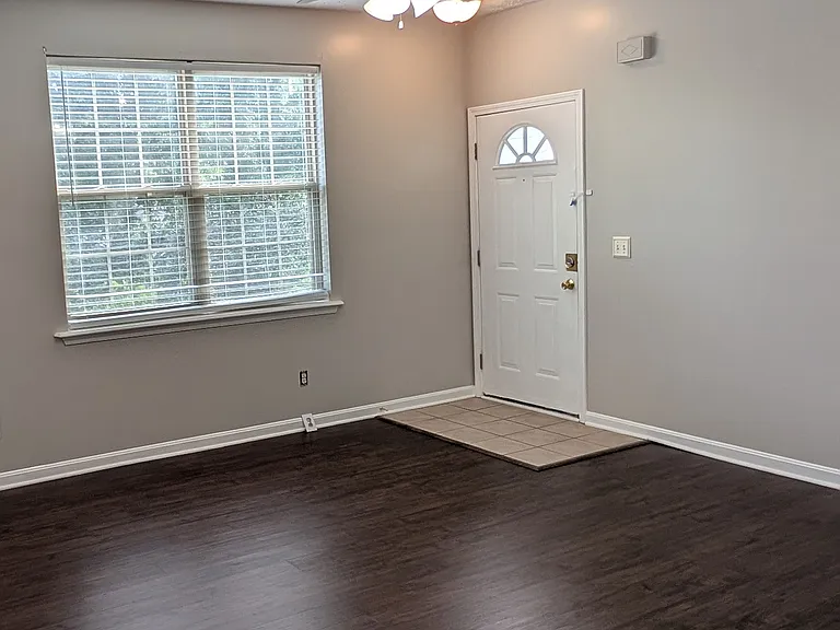 Main entryway featuring tiled foyer, bright window, ceiling fan, and beautiful luxury vinyl flooring