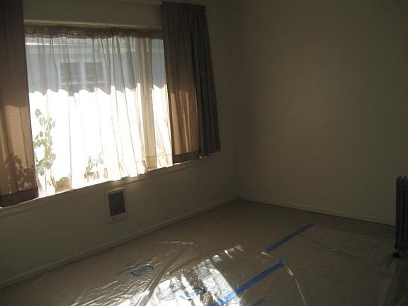 Living room, large window, new carpet (plastic to protect carpet during viewings)