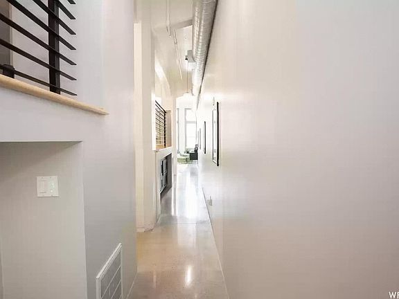 Loft entry - Terrazo floors on lower level with blond hardwood in bedroom areas above