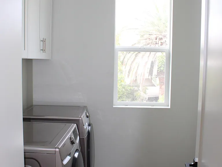 laundry room washer and dryer with plenty of space for storage