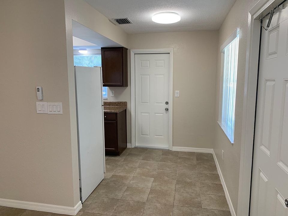 A cozy dinette opens to the kitchen and living room with more natural lighting from the window over the kitchen sink and the front window.