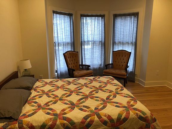 Large bedroom with beautiful bay windows and lots of natural