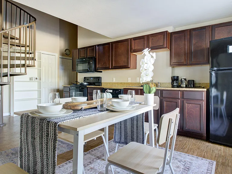 Open kitchen with ample cabinet storage, full-size appliances, and an adjacent dining area for everyday meals.
