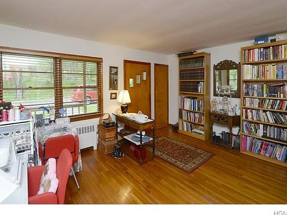 Living room currently being used as a hobby/sewing room. Hardwood floors