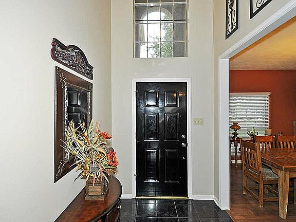 Two story foyer features new light and marble floor.