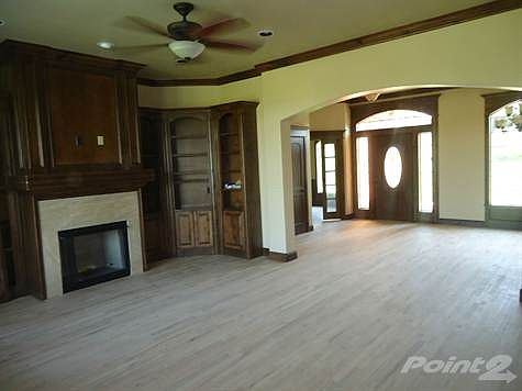 View of living area and entry way from the patio door