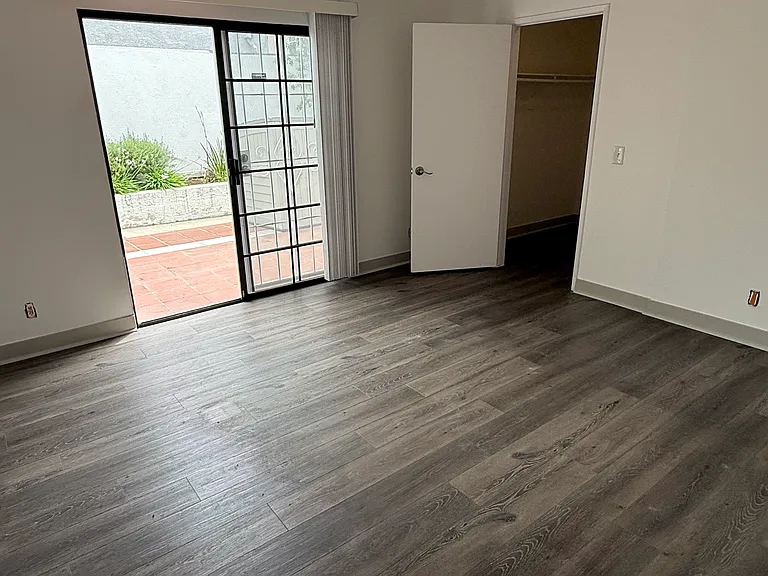 large bedroom with access to private patio