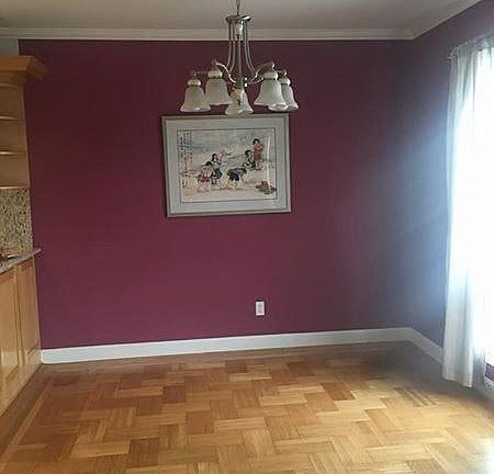 Formal dining room with original hardwood floors.