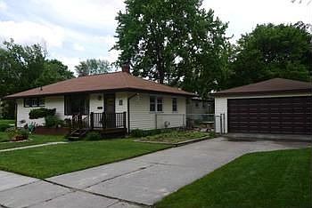 2 car garage with garage door that has been replaced.