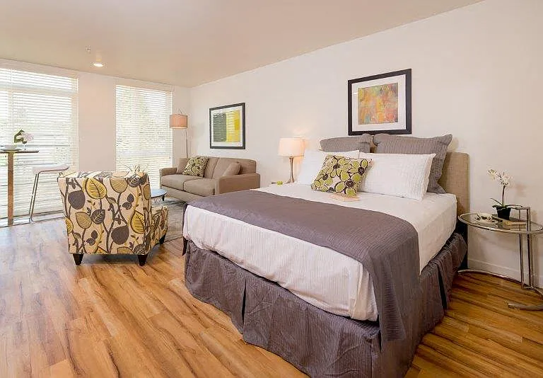 A cozy bedroom in Lillehammer Apartments with ample natural light.