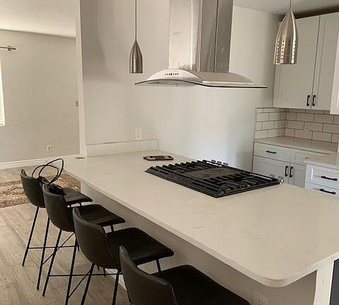 Dining room opened up into kitchen. Beautiful, low maintenance quartz countertops. Gas stove with built-in grill. Lots of lighting options. Counter stools stay!