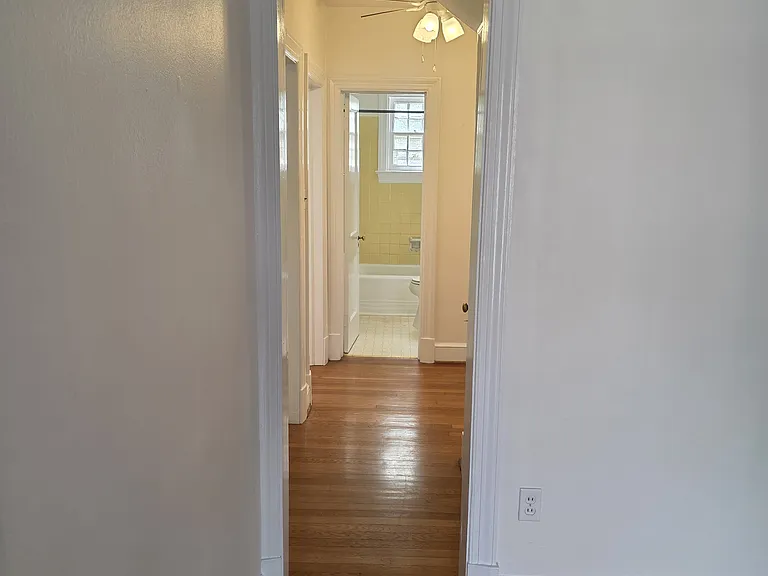 Hallway to the two bedrooms and bath. There is an entrance to the basement for laundry