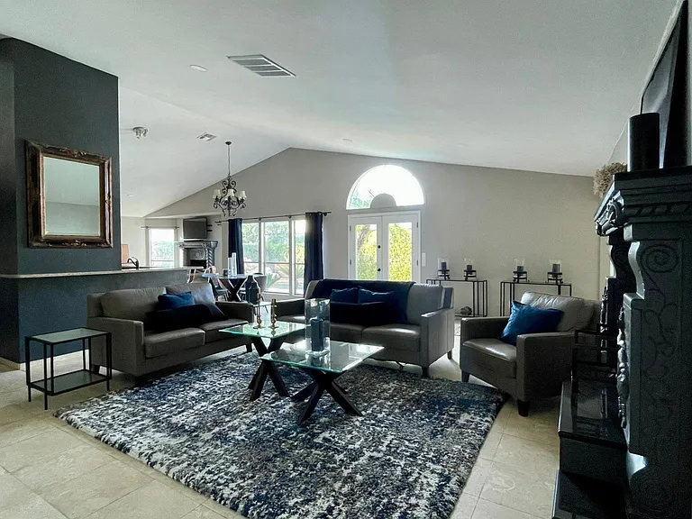 FURNISHED. View from the entry door. Open floor plan, vaulted ceilings, connection outdoor/indoors.