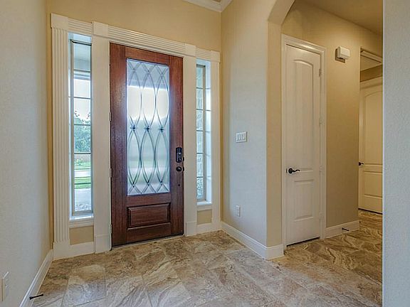 Glassed front door is cased in beautiful mill work and allows natural lighting in !