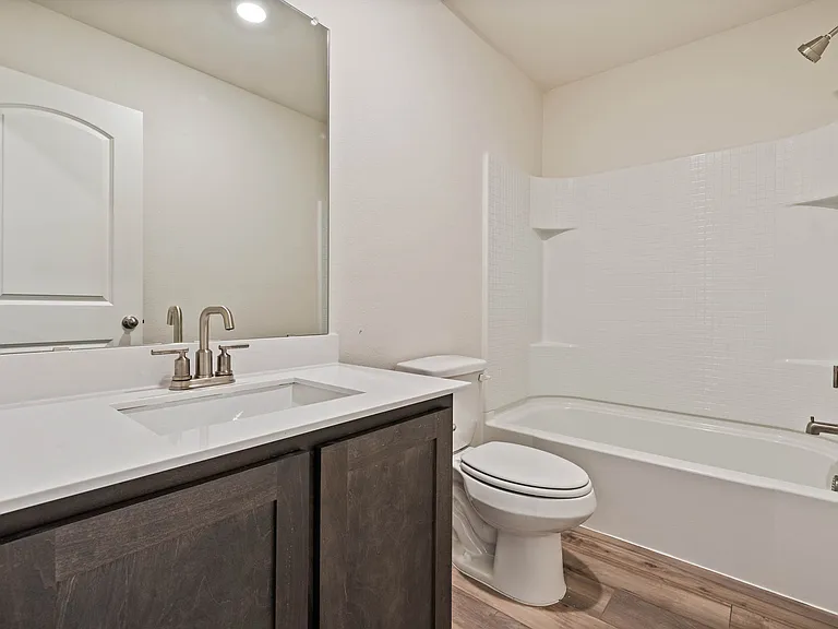 The secondary bathroom has a great vanity and a shower-tub combo.