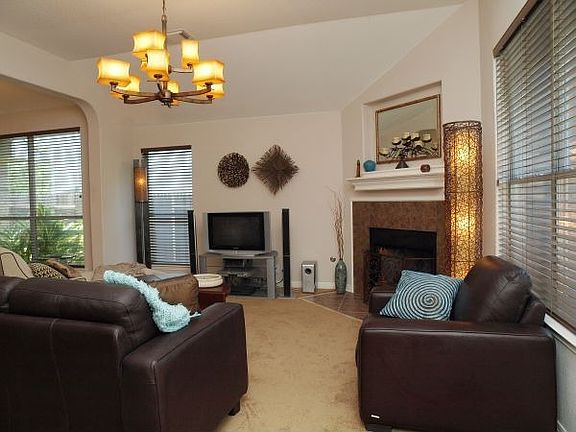 Living room with vaulted ceilings, tiled fireplace