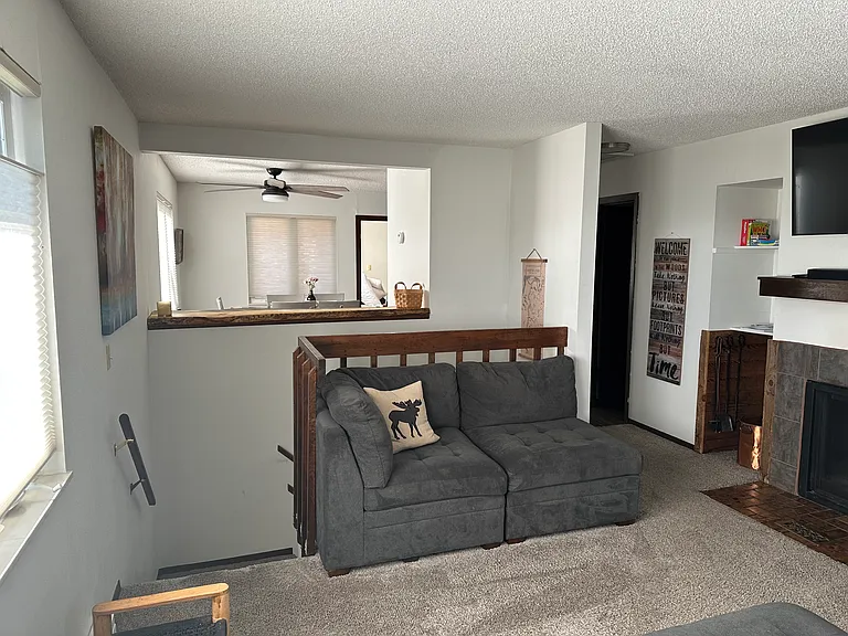 Kitchen and barstool ledge open to living room