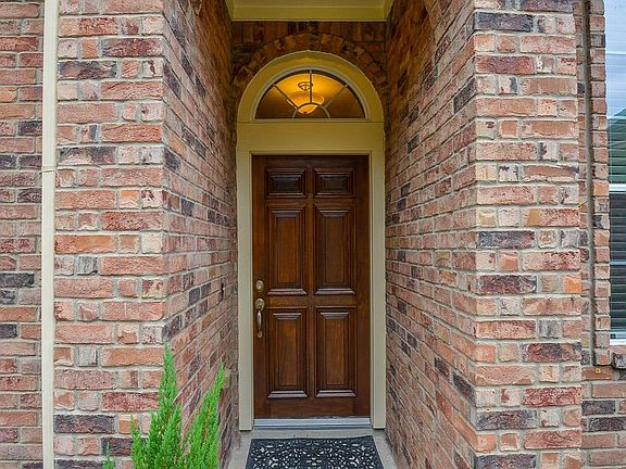 Beautiful bricked entry and a welcoming warm wooden door.