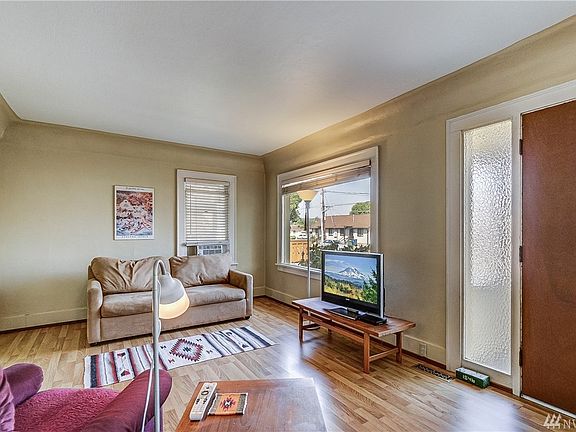 A lovely living room has easy care flooring and a large picture window. 