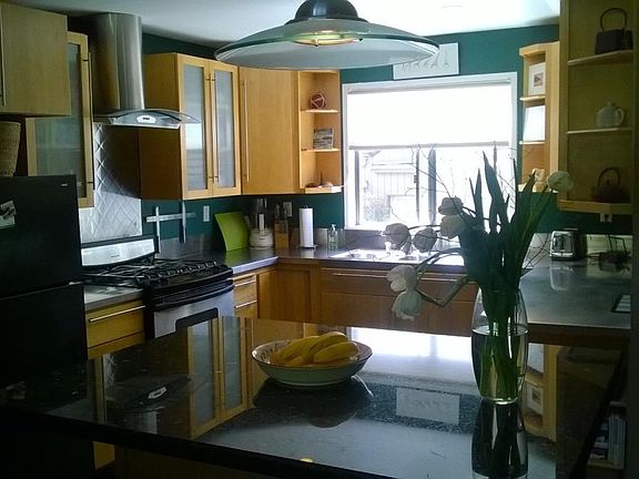 kitchen with stainless countertops and granite island