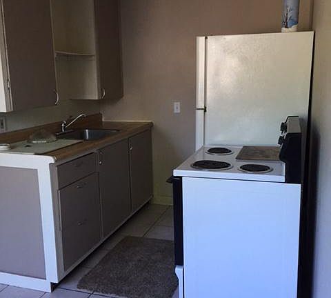 Kitchen with full size appliances, stainless steel sink.