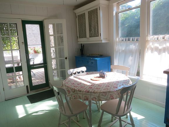 Kitchen opens onto deck with grill