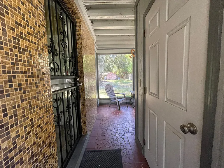 coming into screened porch from the carport (laundry room door on right, kitchen exterior door on left)