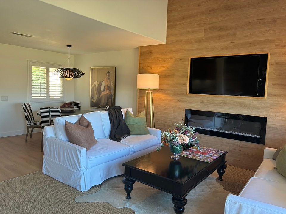 Large open floorpan with built in 60 inch TV and lighted fireplace below.