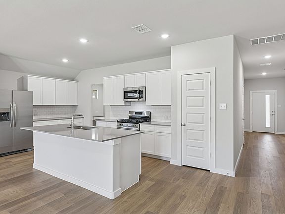 Kitchen in the Harrison home plan by Trophy Signature Homes - REPRESENTATIVE PHOTO