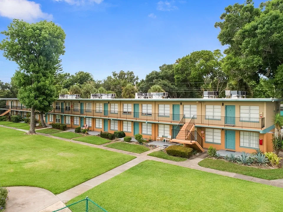 Residents enjoy neatly kept sidewalks and lush green spaces at Park Apartments