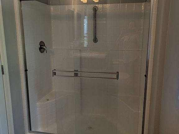 Shower with built in seat in one bedroom