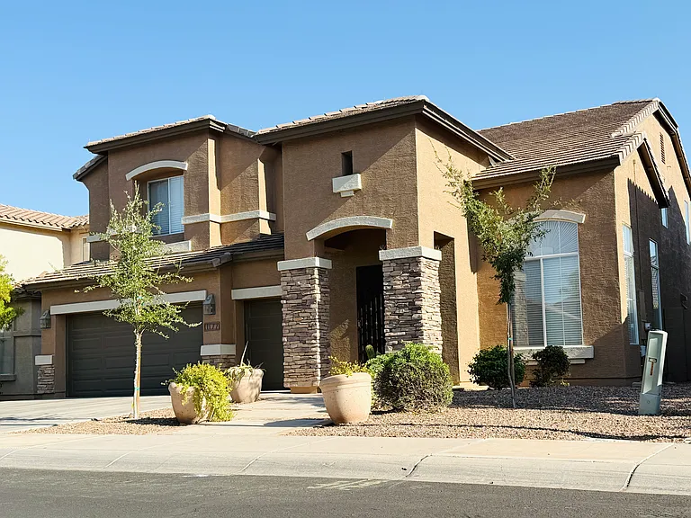 Front exterior of this spacious Camelot-built home in Artemina at The Islands, featuring a 3-car tandem garage.