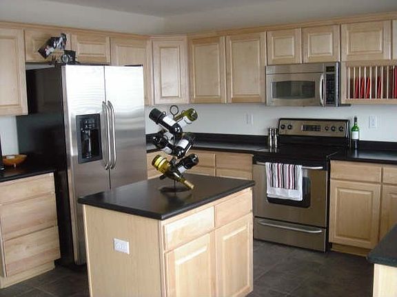 Kitchen w/stainless steell/corian countertops/tile