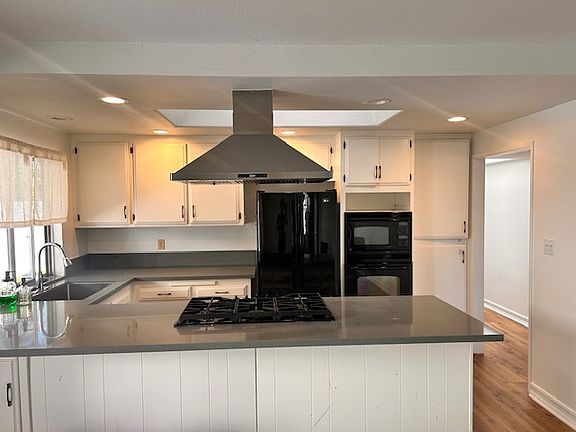 Upgraded kitchen with wall-mounted dual microwave/oven unit; gas cooktop; stainless sink;
