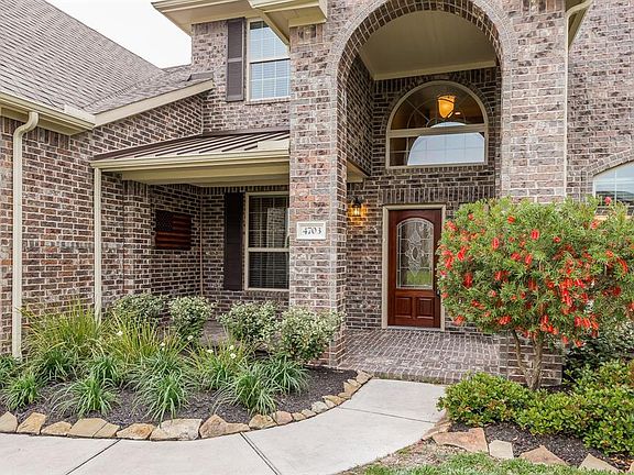 ATTRACTIVE FRONT PORCH WITH BRICK COLUMNS.