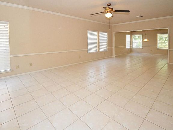 Large walls for amazing artwork and a ceiling fan for comfort! PLUS, cool, white tile floors flow into the formal dining room! The comfortable, neutral tones make it easy to match any decor!