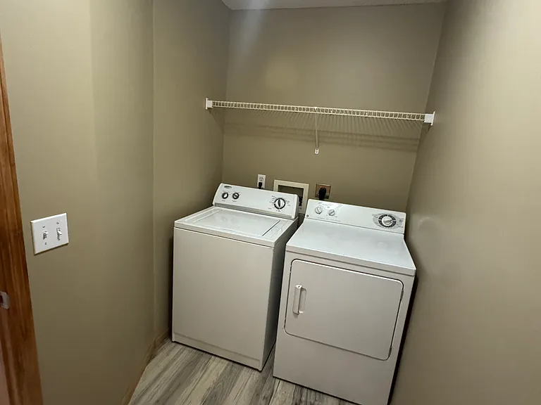 Washer/Dryer room full view with storage