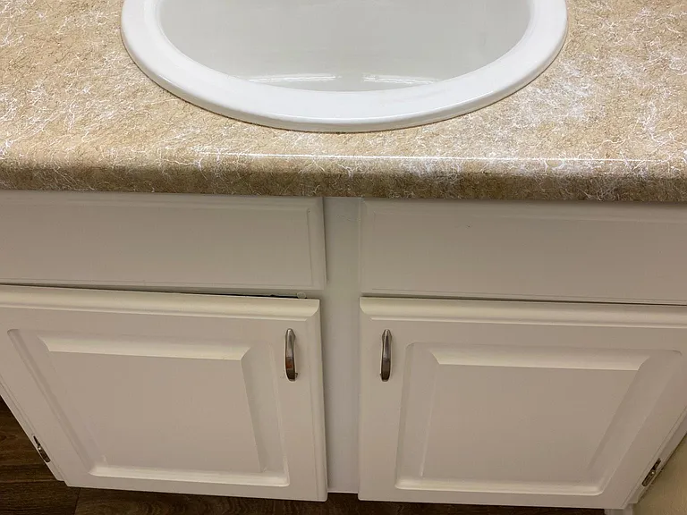 downstairs 2 bedroom - main bedroom bathroom sink and cabinet