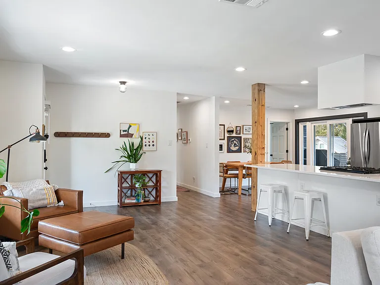 View from living space of entryway, hallway, dining area, and bar