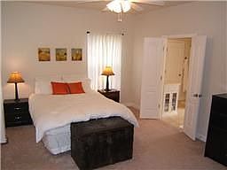 Master bedroom with double door entry into bath