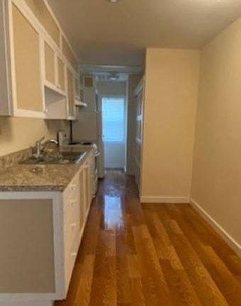 Kitchen with new appliances and pantry storage.